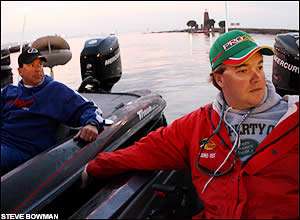 Dean Rojas (left) and Tim Horton (right) visit in the pre-dawn before the start of practice Wednesday morning on Lake Toho.