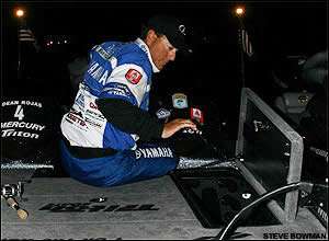 Dean Rojas stows rods while waiting to take off on the first morning of the CITGO Bassmaster Classic.