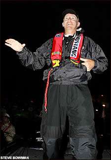 Jeff Reynolds waves to friends and family during the pre-dawn darkness prior to the take off.