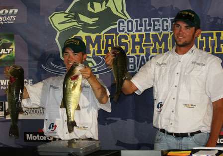 Ray Huddleston and Kevin Koone, of Arkansas Tech University, hold up four of the largemouth bass that led them to victory.