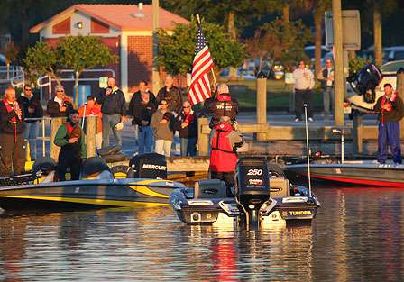Anglers stand for the National Anthem.