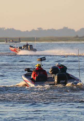 Late boats leave while an angler from an earlier flight fishes a spot close to the weigh-in site.