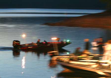 A camera boat motors to the take-off dock just before dawn.
