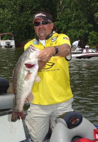 Charlie Sipe holds the 9 lb., 2 oz. bass that won Purolator Big Bass of the Tournament honors for him.  He caught the fish on a jig.
