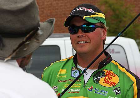 Timmy Horton talks with a fan as he finishes preparing his gear to do battle on Lake Murray.