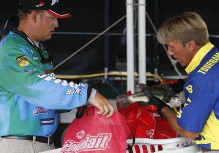 Kurt Dove has his fish checked by BASS official Chris Bath.