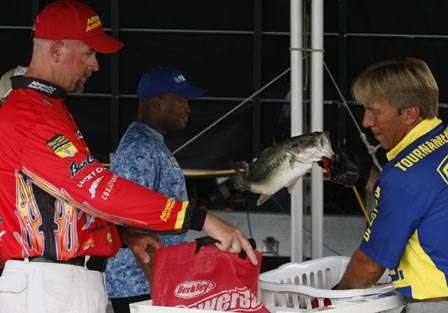 Marty Stone holds his bag open for Chris Bath to return his fish.