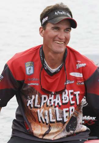 Matt Sphar, who brought in almost 6 pounds less than his co-angler Jeff Freeman, smiles toward some fans on the shore.