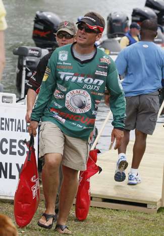 Stephen Browning, who finished just out of the cut in 57th, carries his bag of fish to the weigh-in.