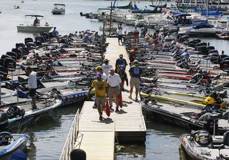 Anglers leave the dock with their bags of fish.