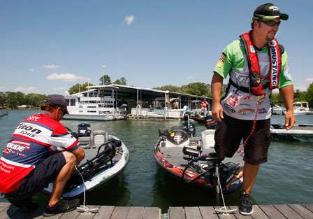 Winner Fred Roumbanis gets off his boat as Davy Hite ties his up after fishing Sunday.