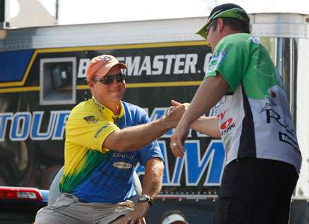 Steve Kennedy shakes hands with Fred Roumbanis before his fish are weighed.