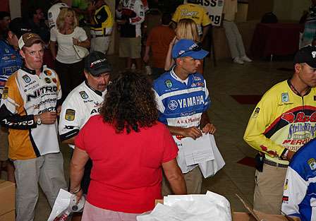 Janet Bell, Director of Angler Relations at BASS, hands out vital information to the pros as they make their way through the registration line.