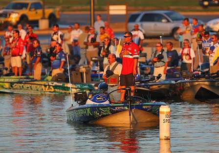 Elite Series pros and their co-anglers stand for the national anthem before launch time.