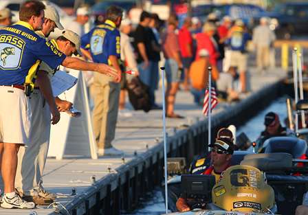 While idling past the livewell check, BASS officials throw a check-in pill to Alabama's Gerald Swindle.
