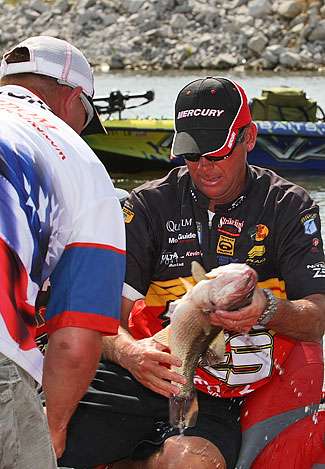 Kevin VanDam pulls one of the fish out of the livewell that would help him move to fifth place with 18 pounds, 8 ounces.