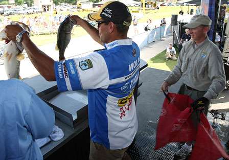 Dave Wolak holds up two of his better fish on the weigh-in stage. Wolak is in third place with 19 pounds, 4 ounces.