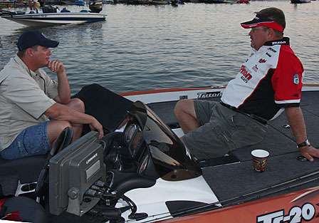 Preston Clark relaxes on the front of his boat while he talks to his co-angler for the day, JP Perkins.