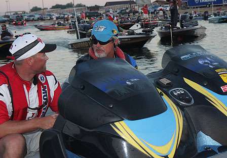 Rick Clunn talks with his co-angler Justin Carter as they wait in line for the launch.
