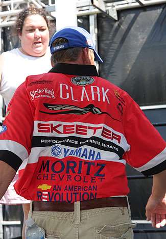 Brian Clark climbs the stairway to the BASS stage at the direction of Janet Bell, the Director of Angler Relations. 