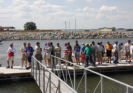 Pros wait for weigh-in bags on the dock as the Alabama sun beats down.