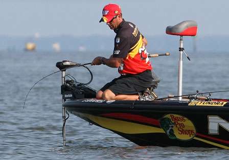 VanDam hooks up with a good fish and fights it gently from the bow of the boat.