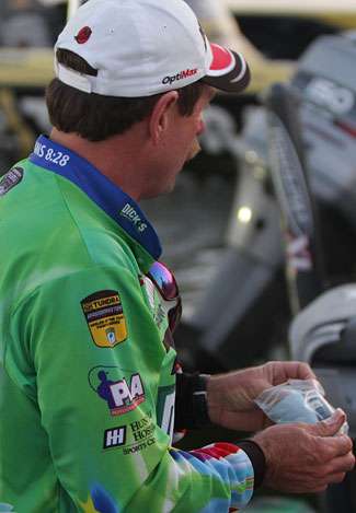 Shaw Grigsby retrieves a cleaning cloth to spruce up his electronic screens as he speaks with media at Ingall's Harbor.