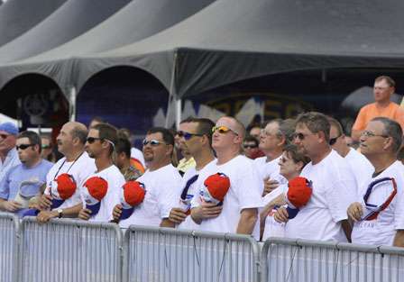 Purolator fans pay homage to the flag as the national anthem echoes through the hot summer air.