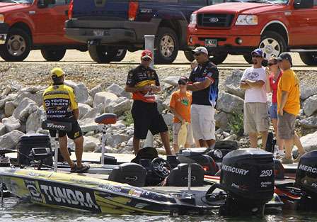 Terry Scroggins, Kevin VanDam and Jeremy Starks visit just across Ingall's Harbor from the weigh-in as they wait for tow vehicles to bring their trailers.