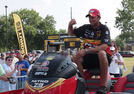 Kevin VanDam fires up the crowd with his trademark fist pump as he is pulled to the stage.
