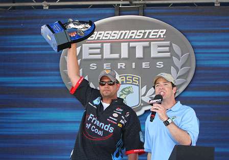 Jeremy Starks holds the Southern Challenge trophy high in the air. 