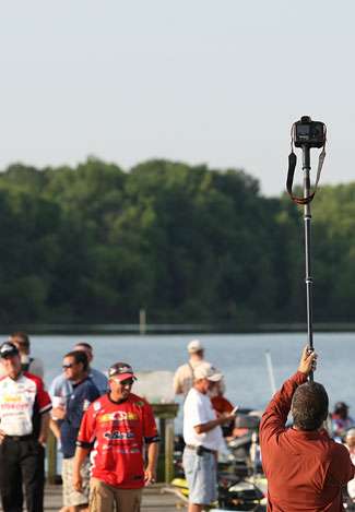 Bassmaster photographer Gary Tramontina raises a camera high into the air to capture a different perspective of the launch area.
