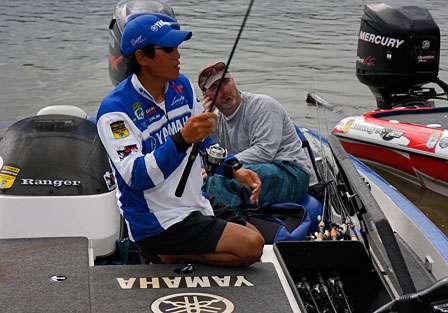 Takahiro Omori puts away his rods as the rain starts to fall harder at the weigh-in on Day Two of the Bluegrass Brawl.