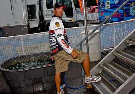 Edwin Evers waits just behind the stage for his turn to weigh-in; he would finish the day in ninth place to fish Saturday when the field will be cut to twelve.