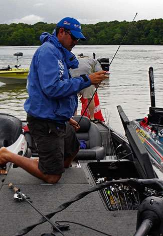 Jared Lintner stows his gear before sacking his bass to head to the weigh-in. 