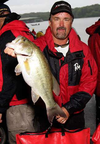 Pete Ponds holds up a fish that would help squeak him into the cut in 48th position.
