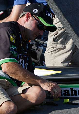 Mike McClelland makes minor changes to his lures by dipping the tips in a chartreuse colored dye.