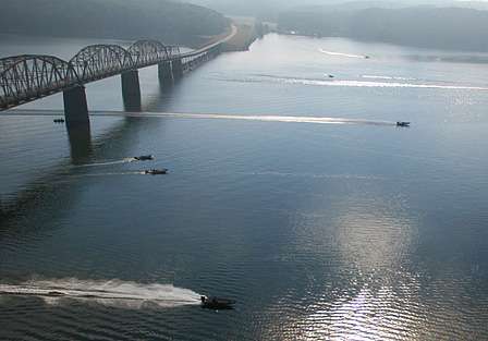A group of boats speeds south on Kentucky Lake, several miles below the launch area at Kentucky Dam Marina.
