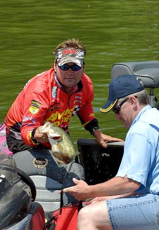 Greg Hackney pulls one of his fish from the livewell that helped him finish Day One in 17th place with 11 pounds, 13 ounces.