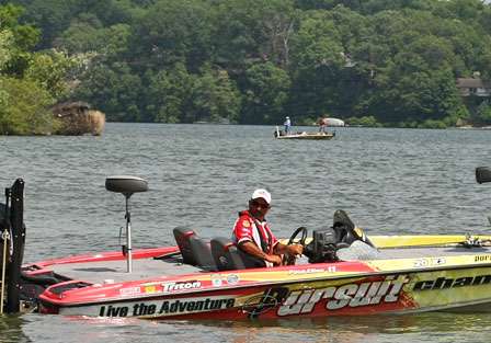 Paul Elias weighed in with an early flight and waits to load his boat on the trailer, while Gary Klein continues to fish in the background.