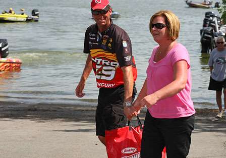 Kevin VanDam's wife Sherry helps him with his weigh-in bag on the way to the scales. There must have been an ample amount of water in the bag as VanDam only managed 7 pounds, 5 ounces on Day One. 