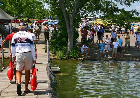 Mike Wurm carries his fish to the scales at the end of Day One. Wurm is back in 85th place with 5 pounds, 5 ounces.