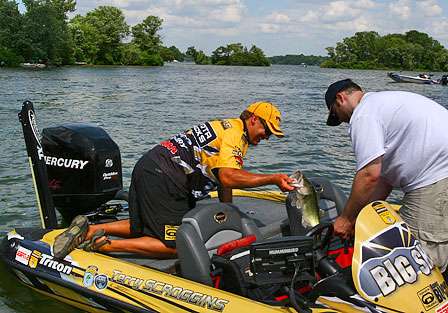 Terry Scroggins loads his weigh-in bag at the end of Day One. Scroggins caught a limit that moved him to ninth place with 13 pounds, 4 ounces. 