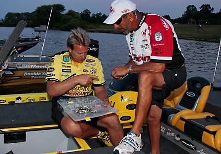Skeet Reese hands Paul Elias a Lucky Craft crankbait and points to it as 