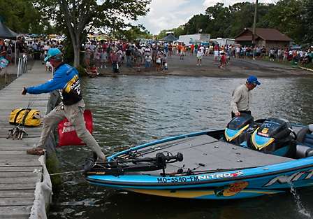 Rick Clunn long-steps his way on to the dock and heads toward the stage as BASS fans line the banks watching the Elite Series pros come back to the dock after a long, hot day on Old Hickory Lake.