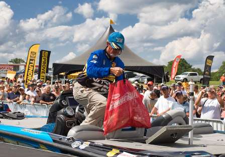 Rick Clunn pulls his weigh-in bag from the livewell, but was one fish shy of his limit. After starting the morning in second place, Clunn faded back to a tie for fifth with 48 pounds, 10 ounces. 