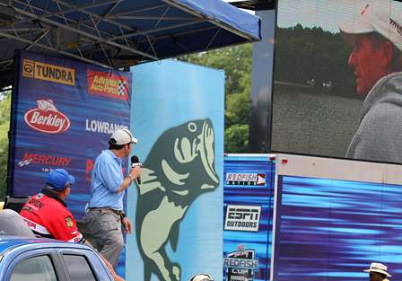 Bill Lowen sits in the 'hot-seat' as the temporary tournament leader, and watches a sampling of Kevin Wirth's day on the water on the jumbotron. 