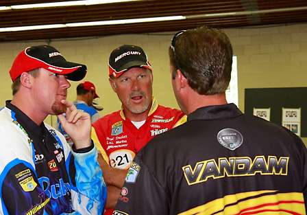 Jason Williamson and Boyd Duckett listen intently to a fish story told by Kevin VanDam.