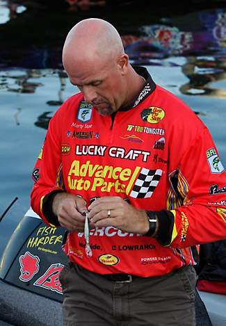 Marty Stone puts custom touches on a crankbait prior to launch on the morning of Day One of the Empire Chase presented by Farmer's Insurance.