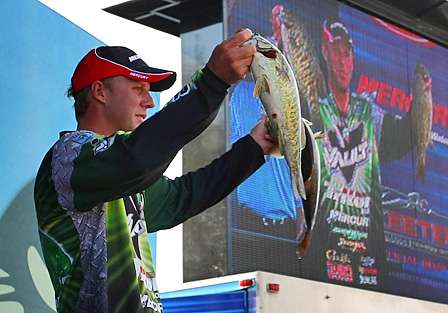 Aaron Martens shows the crowd two of his better fish on Day One.